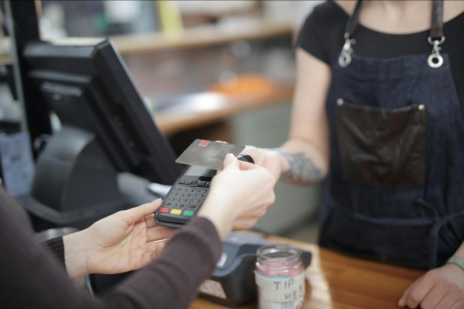 A person purchasing something with their credit card. 